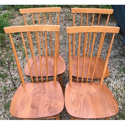 1318 - An Ercol oval drop leaf table with blue label. 113cm x 125cm open, 72cm h together with 4 stick back... 