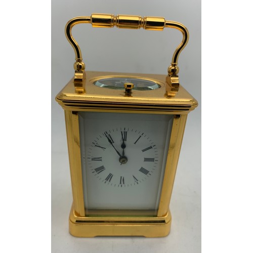 655A - A brass cased carriage clock with repeater mechanism. 13cms h in leather protective case.