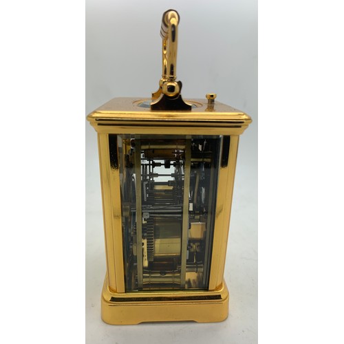 655A - A brass cased carriage clock with repeater mechanism. 13cms h in leather protective case.