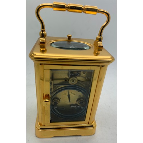 655A - A brass cased carriage clock with repeater mechanism. 13cms h in leather protective case.