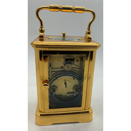 655A - A brass cased carriage clock with repeater mechanism. 13cms h in leather protective case.