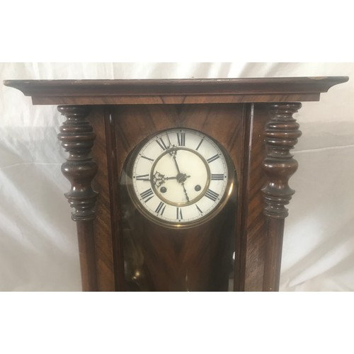 656A - Walnut cased pendulum wall clock, enamel dial, roman numerals. 94 h x 41 w x 18cms d.