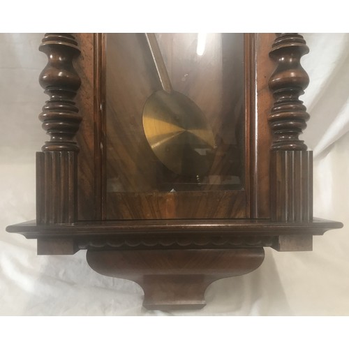 656A - Walnut cased pendulum wall clock, enamel dial, roman numerals. 94 h x 41 w x 18cms d.