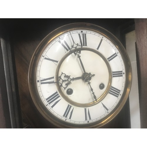 656A - Walnut cased pendulum wall clock, enamel dial, roman numerals. 94 h x 41 w x 18cms d.