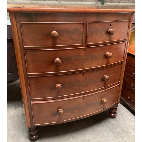 1197B - A Victorian bowfront chest of drawers. 2 short over 3 long drawers on turned legs. 108 w x 54 d x 12... 