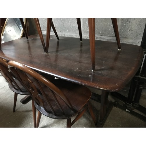 1205B - An Ercol refectory dark wood dining table and 4 stick back dining chairs. Table 138 w x 77 d x 72cms... 