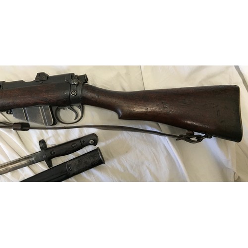 670 - A Lee Enfield SMLE Number 1 MKIII 303 rifle deactivated, number W3802 with a 1907 leather sheathed b... 