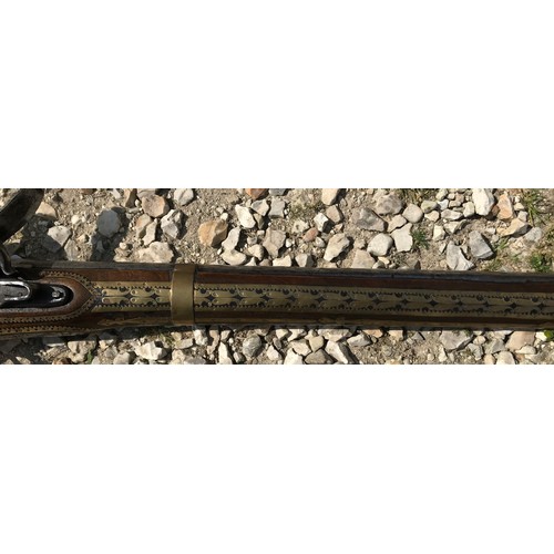 680 - Northwest Frontier Flintlock musket, 54'' tapered smooth bone barrel, stock heavily decorated with i... 