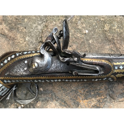 684 - Northwest Frontier Flintlock Musket with a 45'' tapered and ribbed barrel, stock heavily decorated w... 