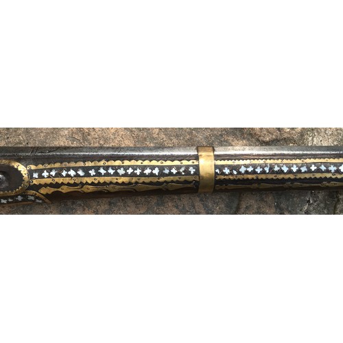 684 - Northwest Frontier Flintlock Musket with a 45'' tapered and ribbed barrel, stock heavily decorated w... 