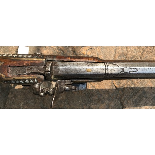 684 - Northwest Frontier Flintlock Musket with a 45'' tapered and ribbed barrel, stock heavily decorated w... 