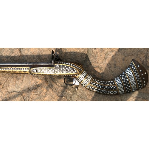 684 - Northwest Frontier Flintlock Musket with a 45'' tapered and ribbed barrel, stock heavily decorated w... 