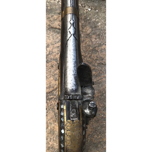 687 - Northwest Frontier musket with a 41'' barrel, stock heavily decorated with inlaid brass and mother o... 