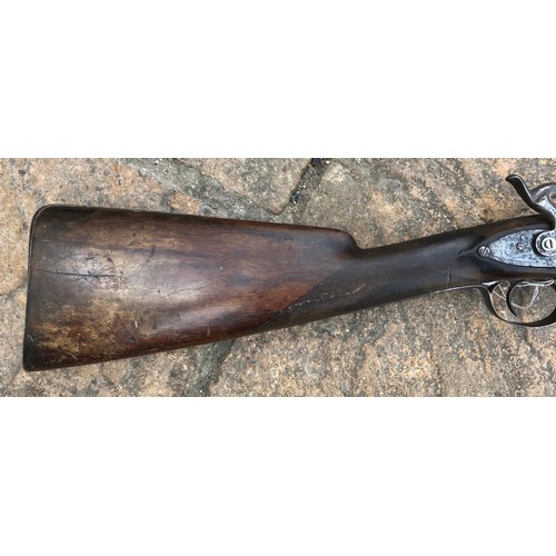 693 - A 19thC single bore rifle steel barrel, length 80cms, wooden ramrod under barrel, engraved steel sho... 