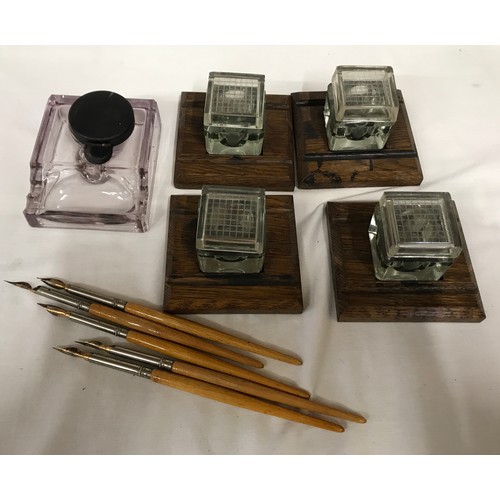 788 - Stationary, 4 x oak based inkwells with glass inkpots 11cms w x 7.5cms h and one glass inkwell 10cms... 