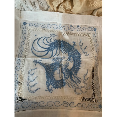 468 - A quantity of good quality hand embroidered table cloths to include Chinese silk crocheted etc.