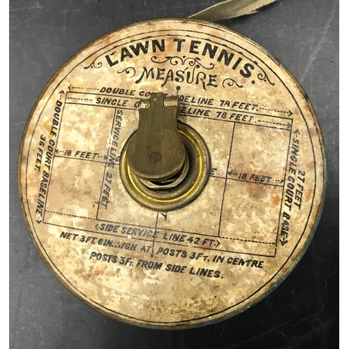 781 - A brass cased lawn tennis measure tape with paper label instructions, 10cms w.