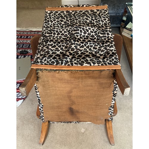 1230 - A mid century leopard design upholstered chair.