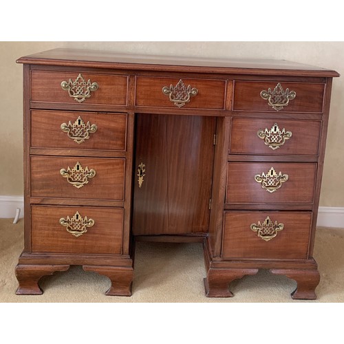 1235 - A 19thC mahogany kneehole desk with brass fittings and ogee bracket feet. 95 w x 50 d x 82cm d.