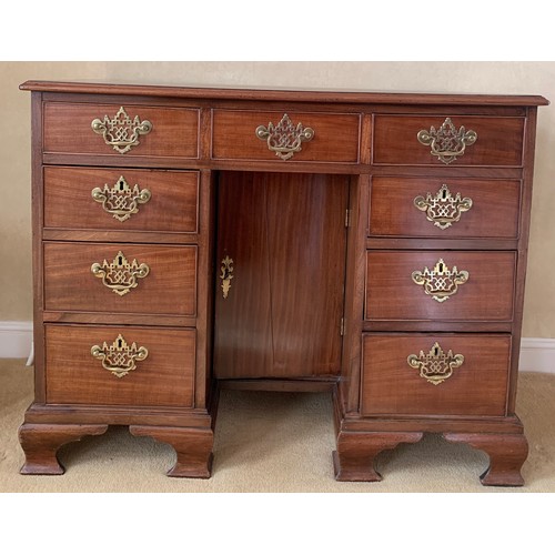 1235 - A 19thC mahogany kneehole desk with brass fittings and ogee bracket feet. 95 w x 50 d x 82cm d.