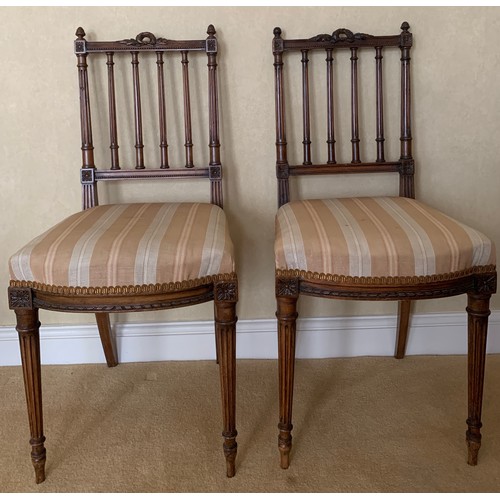 1239 - Two side chairs in the French manner with decorative top rails.