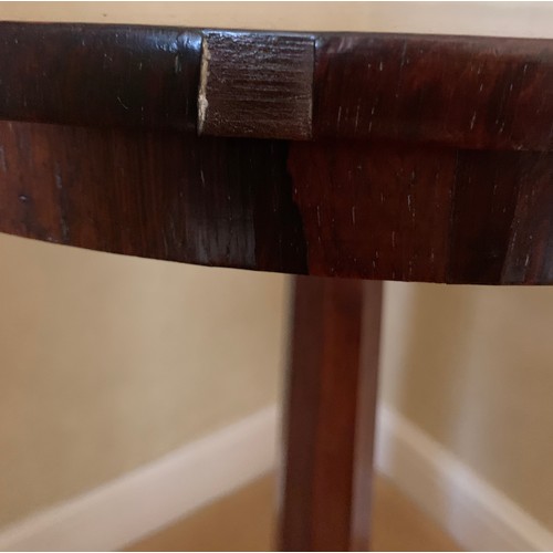 1241 - A rosewood occasional table. 53 d x 73 cm h.