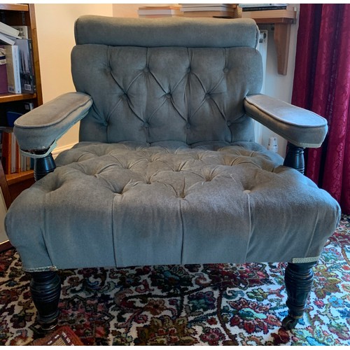 1243 - A 19thC upholstered open armchair with ebonised legs to front and buttoned seat. 68cm w to seat.