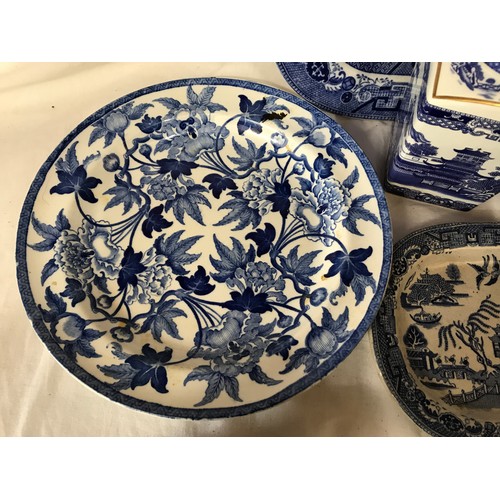 191 - A selection of blue and white pottery to include Willow pattern meat plates 27 and 18cm, dinner plat... 