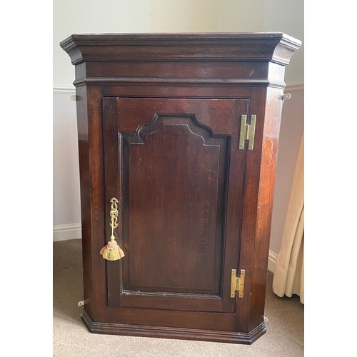 1255 - A 19thC single door oak corner cupboard with H hinges and 2 shelves to the interior. 80 w x 108 h x ... 