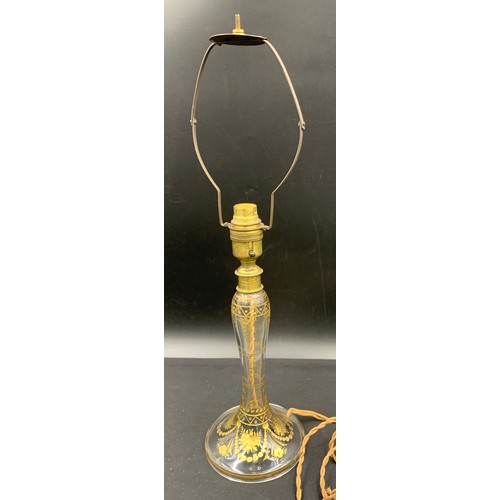 516 - A clear glass and gilt table lamp. 31cm to top of fitting.