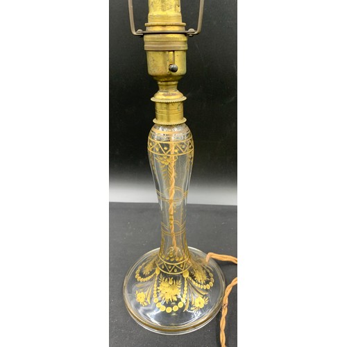 516 - A clear glass and gilt table lamp. 31cm to top of fitting.