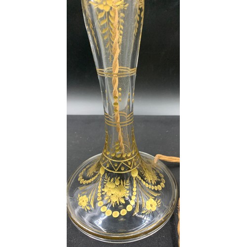 516 - A clear glass and gilt table lamp. 31cm to top of fitting.