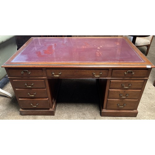 1263 - A mahogany kneehole desk with leather and glass top. 152 w x 90 x 77cm h.