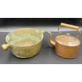 A copper kettle 22 h x 22.5cm w together with a brass two handled pan 11.5 h x 31cm w.