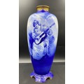 A Royal Doulton blue & white vase depicting a lady playing a guitar. Height 43 cm.