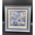 A Moorcroft framed blue and white relief tile depicting faces and hands in waves. Frame 32.5 x 32.5c... 
