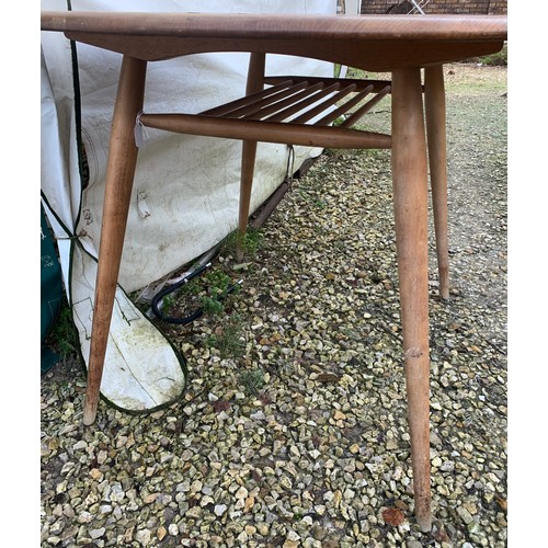 1265 - An Ercol oval topped dining table with under rack shelf and blue label. Top 99 x 89 x 73cm h