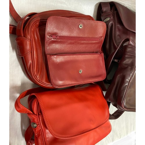 488 - Eleven leather hand bag and purses in red hues to include a maroon two handled handbag 28 w x 35.5cm... 