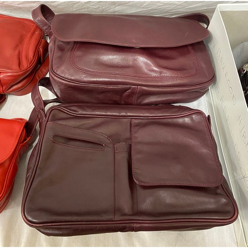 488 - Eleven leather hand bag and purses in red hues to include a maroon two handled handbag 28 w x 35.5cm... 