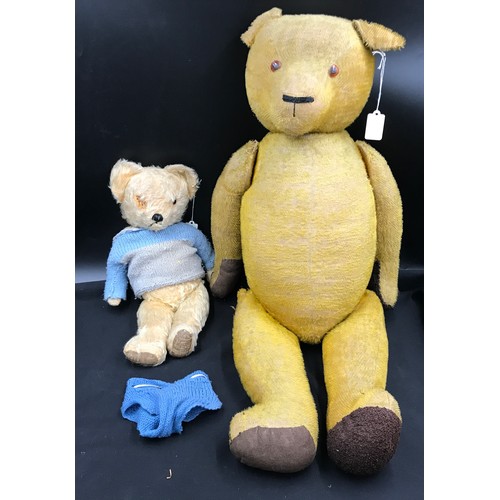 764 - A vintage straw filled teddy bear 83cm h together with vintage teddy with growler mechanism 41cm h.