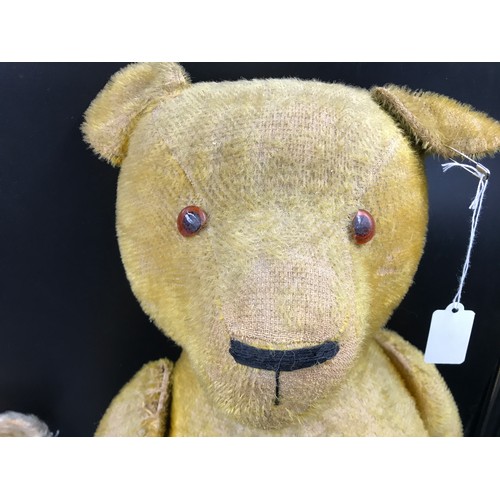 764 - A vintage straw filled teddy bear 83cm h together with vintage teddy with growler mechanism 41cm h.