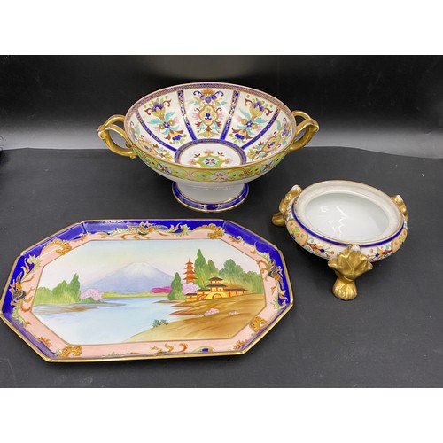 64 - A Noritake twin handled pedestal bowl with floral decoration. 11.5 x 31cm, tripod dish (no lid) 18cm... 