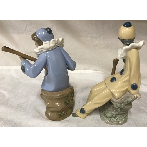 79 - Nao Lladro pair of figures, musicians with instruments. 19 and 20cm h.