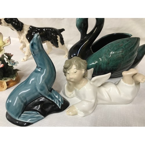 81 - A mixed lot of ceramics  to include: Lladro angel 7cm h, Poole seal 11cm h, Capodimonte flower 12cm ... 