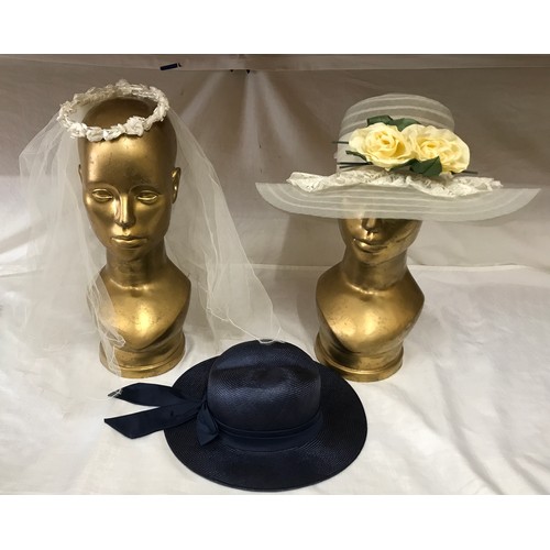 476 - A wedding veil with floral head band, a ladies navy hat and a wedding hat with ribbon, bow and flowe... 