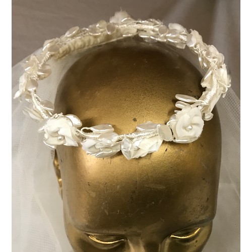 476 - A wedding veil with floral head band, a ladies navy hat and a wedding hat with ribbon, bow and flowe... 