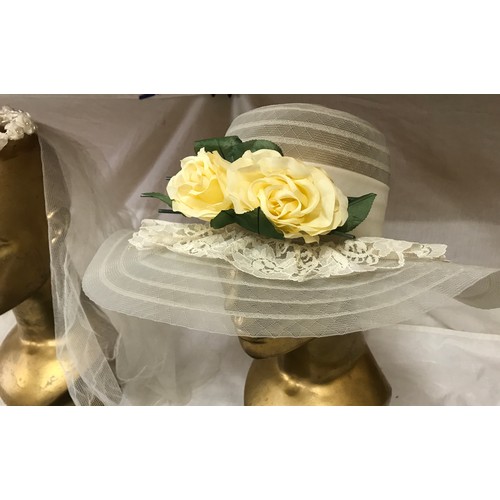 476 - A wedding veil with floral head band, a ladies navy hat and a wedding hat with ribbon, bow and flowe... 