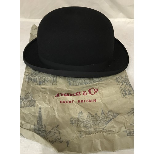 477 - A Dunn & Co black bowler hat size 7 1/4 with retail paper bag.