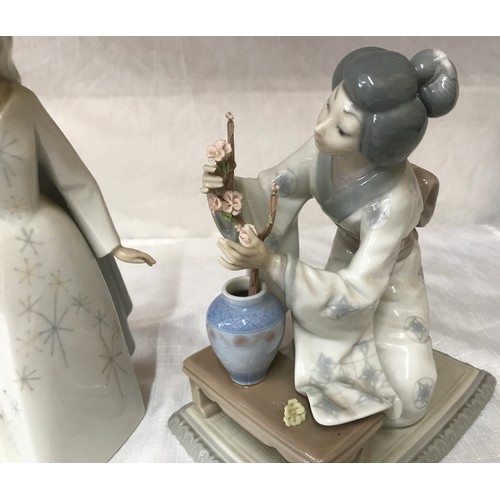 84 - Two  Lladro figurines, a Japanese girl arranging cherry blossom 19 h x 12 w x 16 at base and a wizar... 