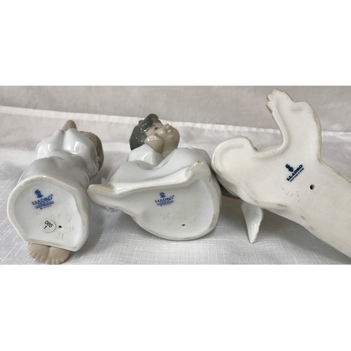 86 - Three Lladro angel figurines, kneeling 14cm, sitting 11cm and laid 7cm.